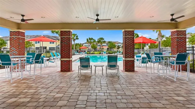 a dining room with furniture a rug and a floor to ceiling window