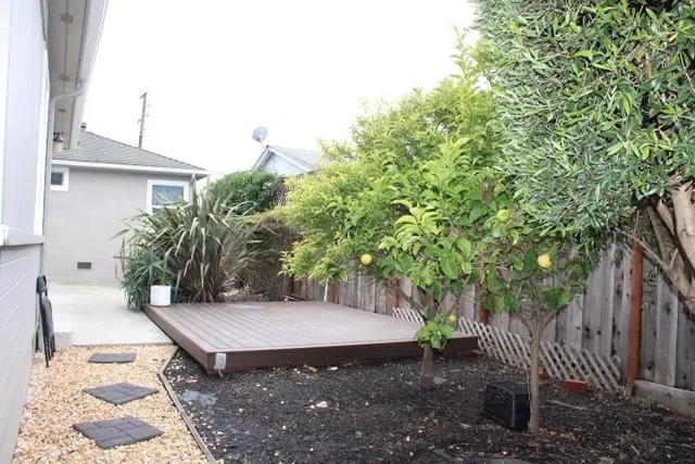 a wooden bench sitting in backside of a house with wooden floor
