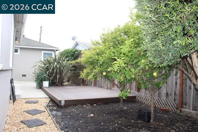 a view of a bench in the backyard of house