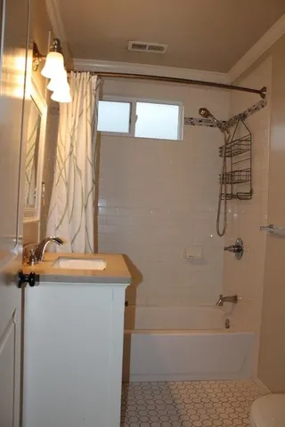 a bathroom with a sink a mirror and a shower