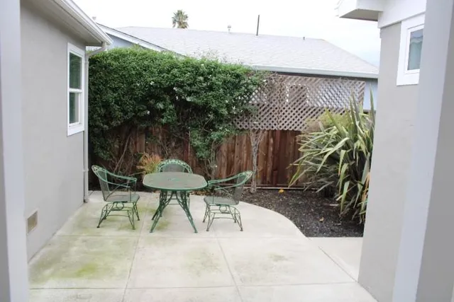 a view of a patio with table and chairs potted plants with wooden floor