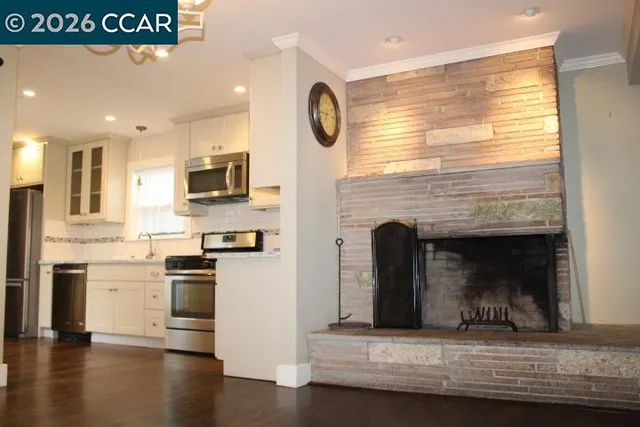 a kitchen with stainless steel appliances granite countertop a stove top oven a sink and a microwave