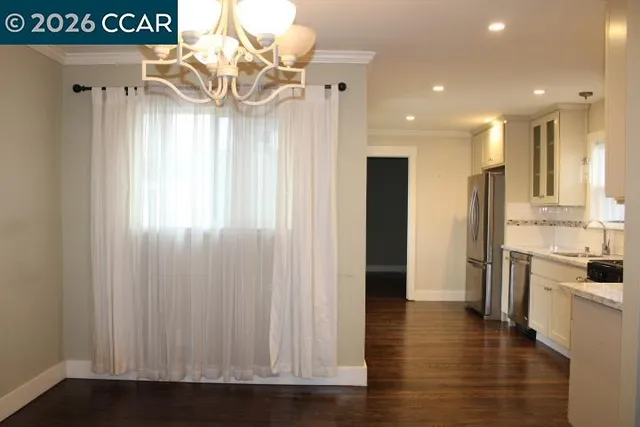 a view of a kitchen with a refrigerator and a stove
