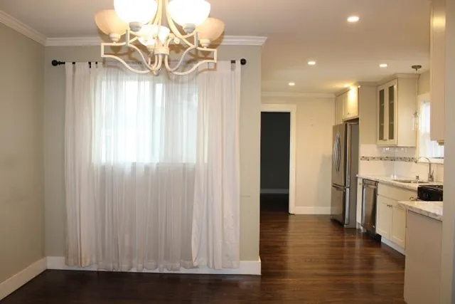 a view of a kitchen with a sink and refrigerator