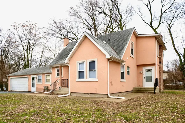 a house that has a tree in front of it