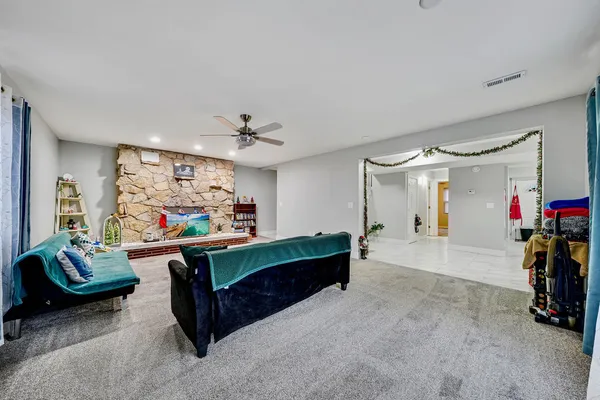 a living room with furniture and a chandelier