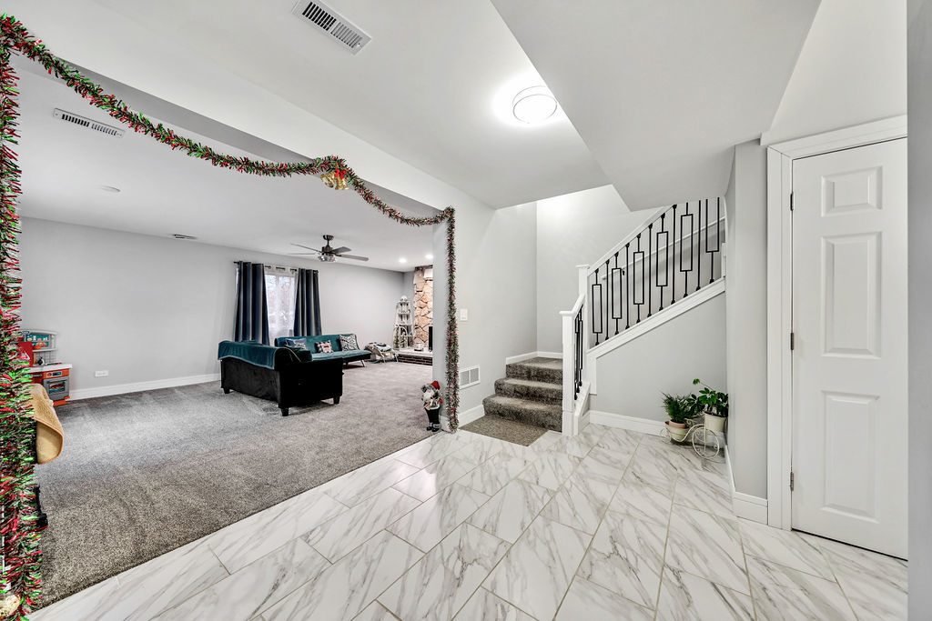 3315 West 161st Street Markham, IL 60428 - Photo 12 of 26 a view of a livingroom with furniture stairs and a living room