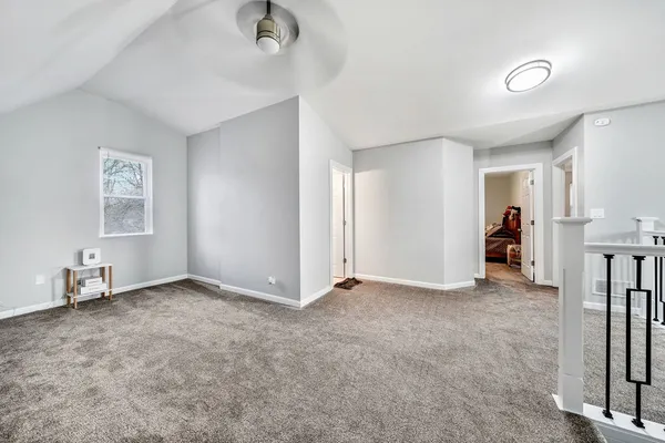 an empty room with closet and a window