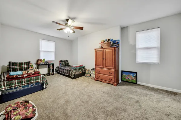 a living room with furniture a flat screen tv and a window