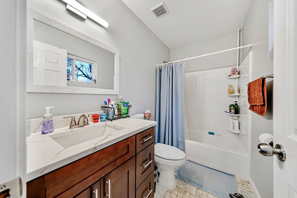 3315 West 161st Street Markham, IL 60428 - Photo 17 of 26 a bathroom with a sink a toilet a shower and a mirror