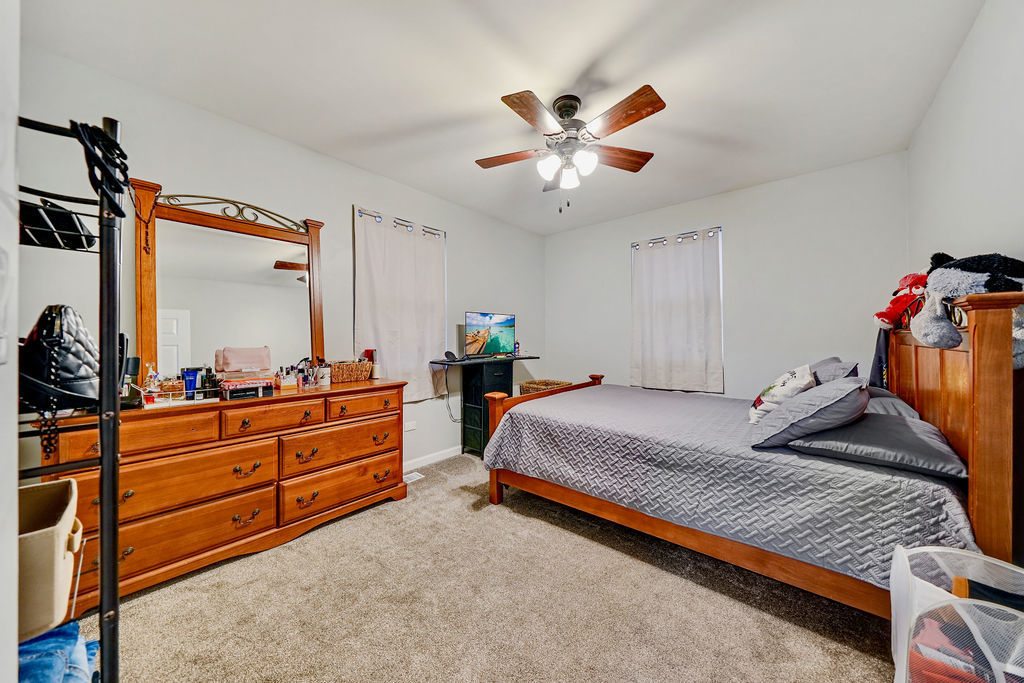 3315 West 161st Street Markham, IL 60428 - Photo 18 of 26 a bed room with a bed and a chandelier