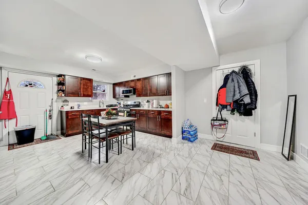 a view of a kitchen with fridge and wooden floor