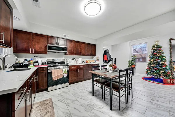 a kitchen with a table and chairs in it