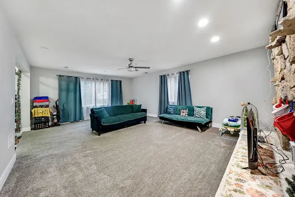 a living room with furniture gym equipment and a fireplace