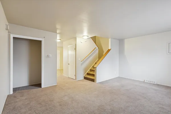 a view of an empty room with stairs