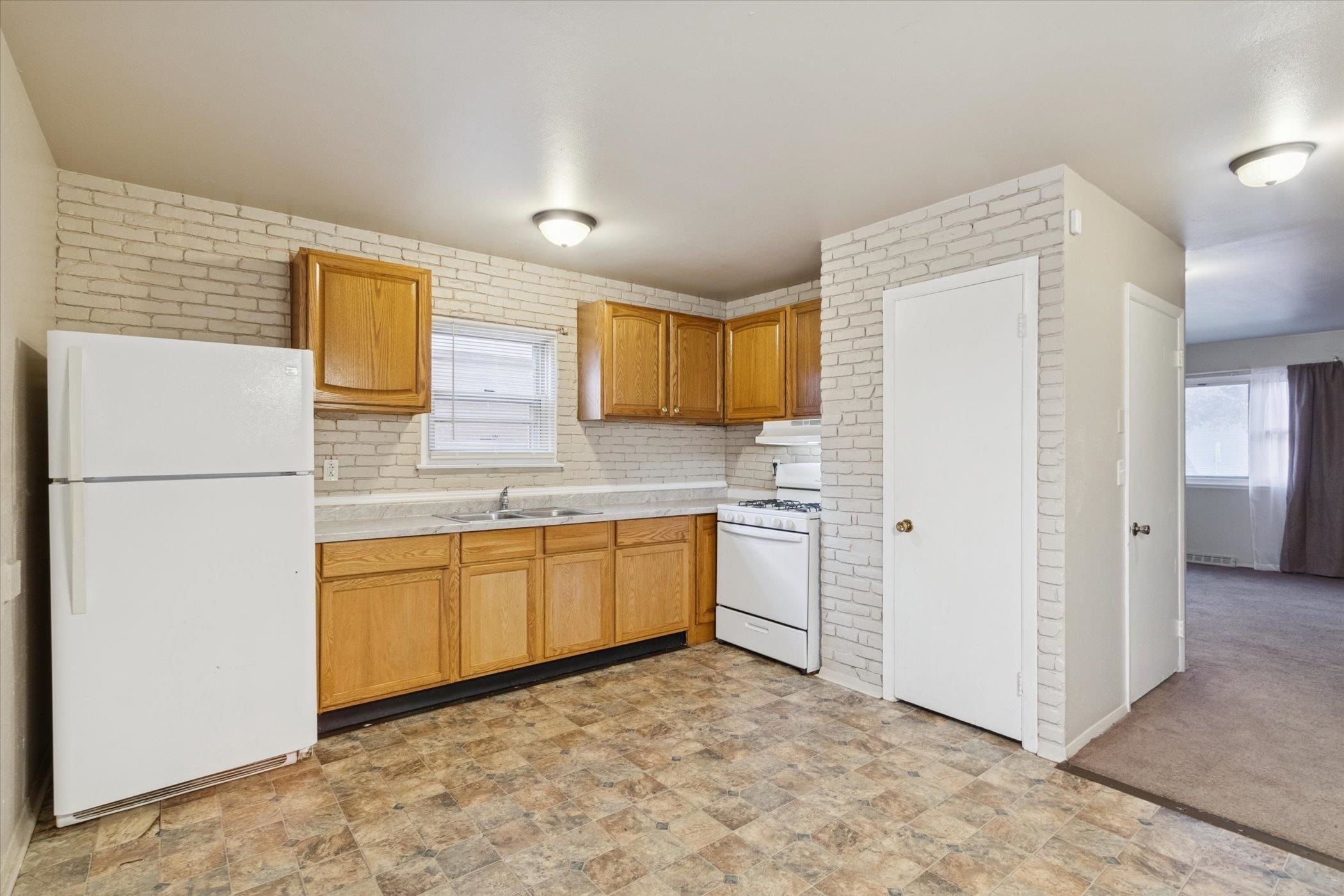 1120 Lincoln Avenue Rockford, IL 61102 - Photo 5 of 12 a kitchen with stainless steel appliances granite countertop a refrigerator sink and cabinets