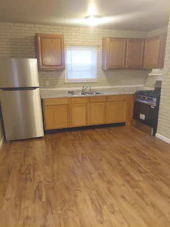 a kitchen with stainless steel appliances a refrigerator sink and cabinets
