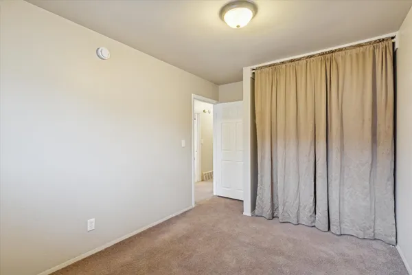 a view of a room with a wooden door