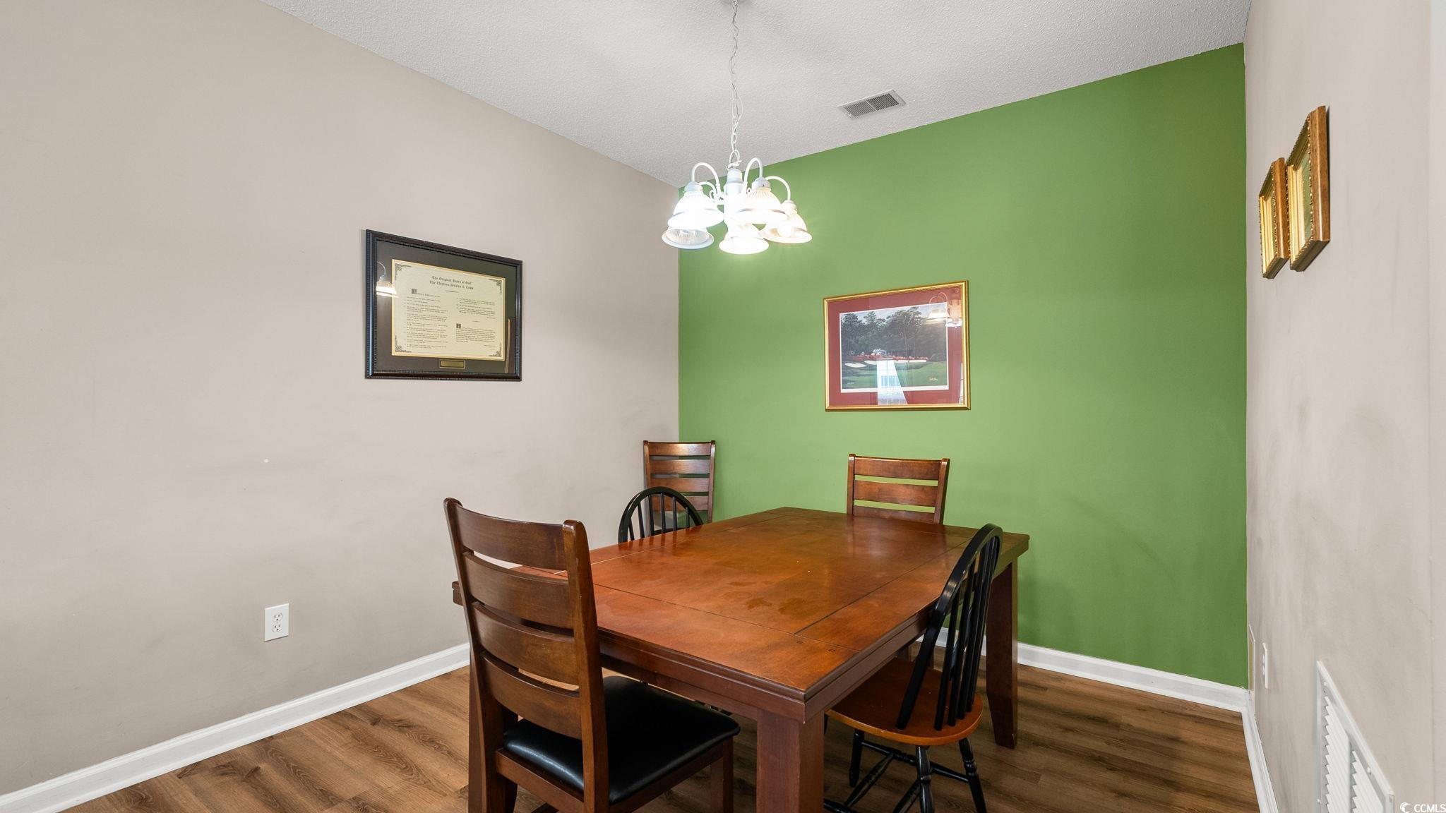 4431 Montrose Lane, Unit A Myrtle Beach, SC 29579 - Photo 11 of 32 Dining space with a chandelier and dark wood-type flooring