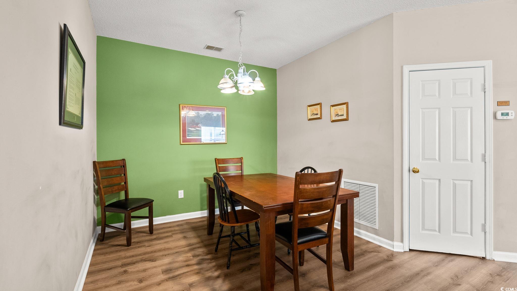 4431 Montrose Lane, Unit A Myrtle Beach, SC 29579 - Photo 12 of 32 Dining space with a chandelier and wood finished floors