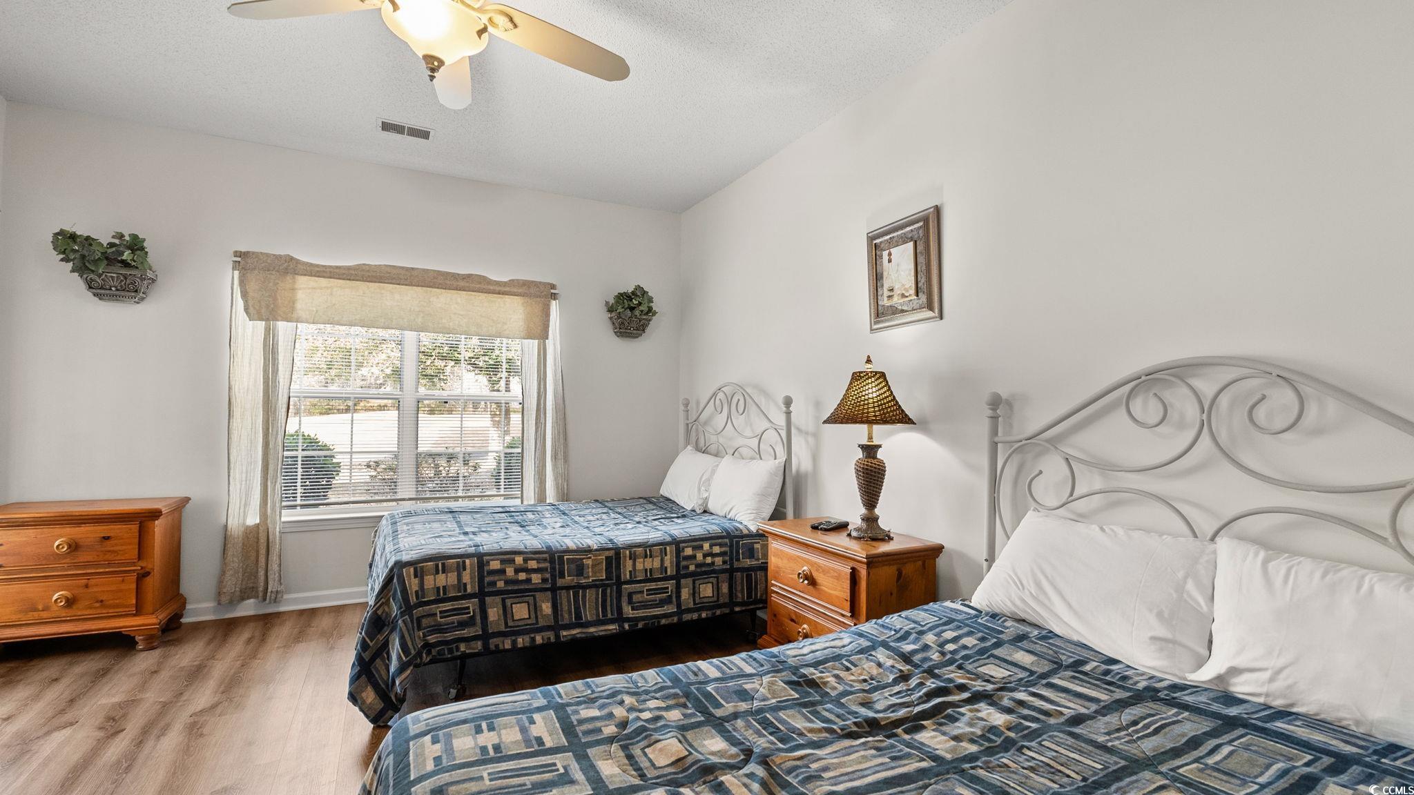 4431 Montrose Lane, Unit A Myrtle Beach, SC 29579 - Photo 13 of 32 Bedroom with wood finished floors, ceiling fan, and a textured ceiling
