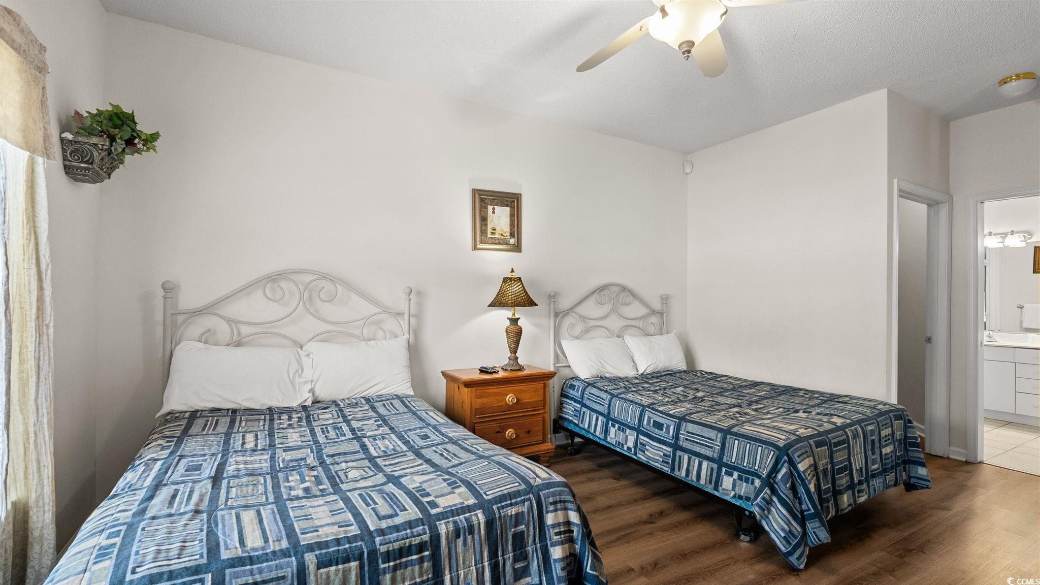4431 Montrose Lane, Unit A Myrtle Beach, SC 29579 - Photo 15 of 32 Bedroom featuring wood finished floors, a ceiling fan, and ensuite bath
