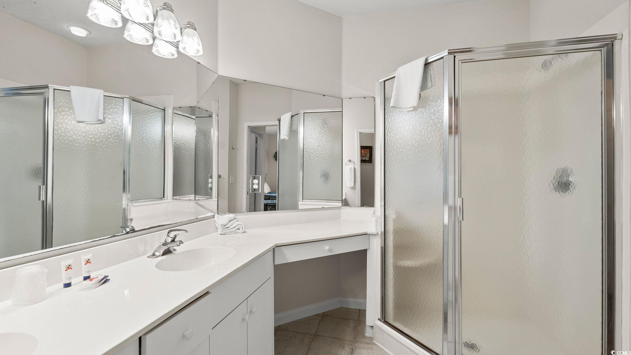 4431 Montrose Lane, Unit A Myrtle Beach, SC 29579 - Photo 19 of 32 Full bath featuring double vanity, a stall shower, and light tile patterned floors