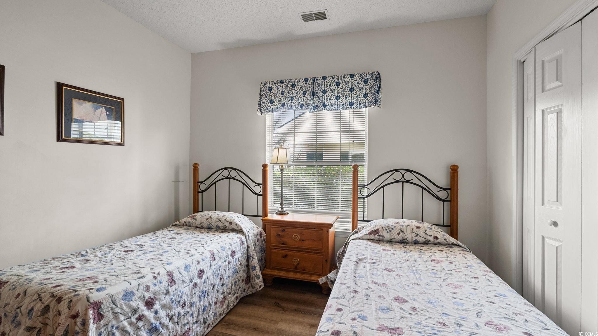 4431 Montrose Lane, Unit A Myrtle Beach, SC 29579 - Photo 20 of 32 Bedroom featuring dark wood-type flooring, a closet, and a textured ceiling