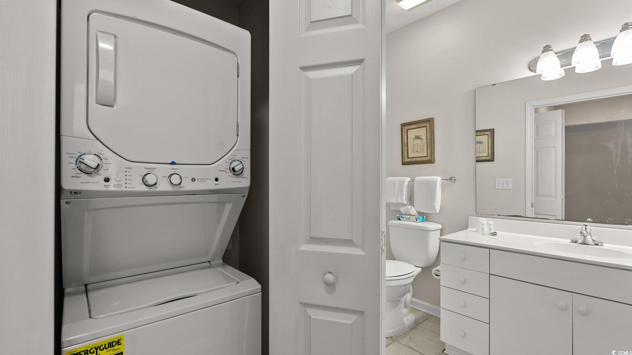 4431 Montrose Lane, Unit A Myrtle Beach, SC 29579 - Photo 22 of 32 Bathroom with vanity, stacked washer and clothes dryer, and light tile patterned flooring