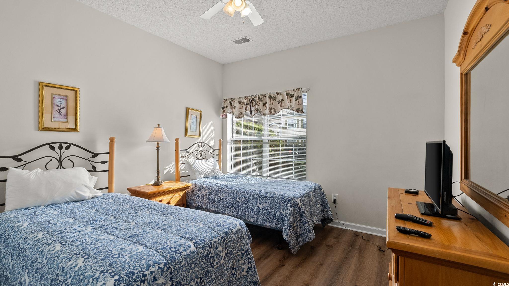4431 Montrose Lane, Unit A Myrtle Beach, SC 29579 - Photo 24 of 32 Bedroom with dark wood-style flooring, a ceiling fan, and a textured ceiling