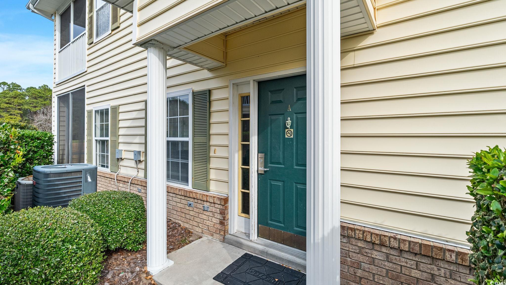 4431 Montrose Lane, Unit A Myrtle Beach, SC 29579 - Photo 3 of 32 View of exterior entry featuring brick siding