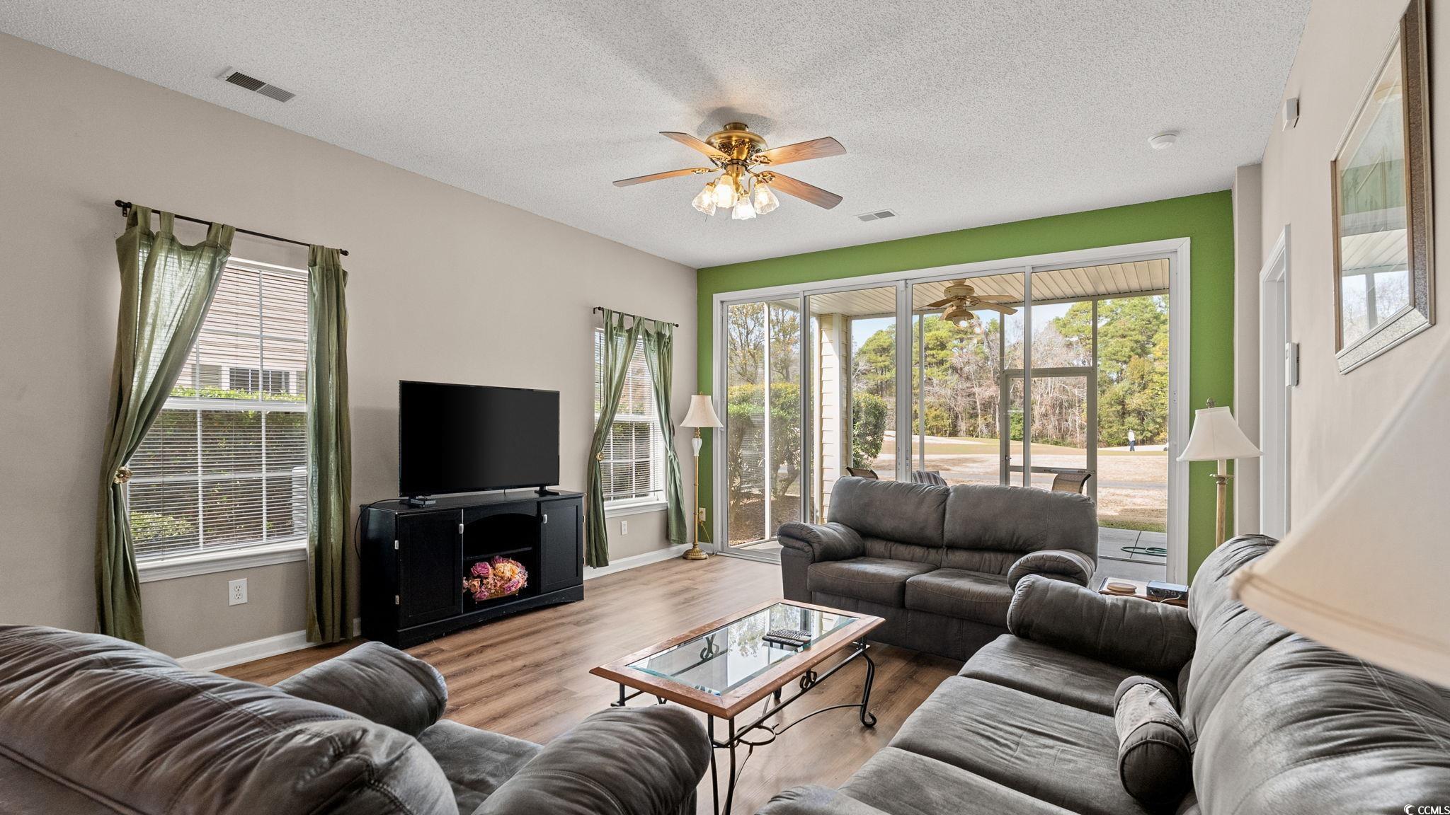 4431 Montrose Lane, Unit A Myrtle Beach, SC 29579 - Photo 6 of 32 Living area with a textured ceiling, wood finished floors, and ceiling fan