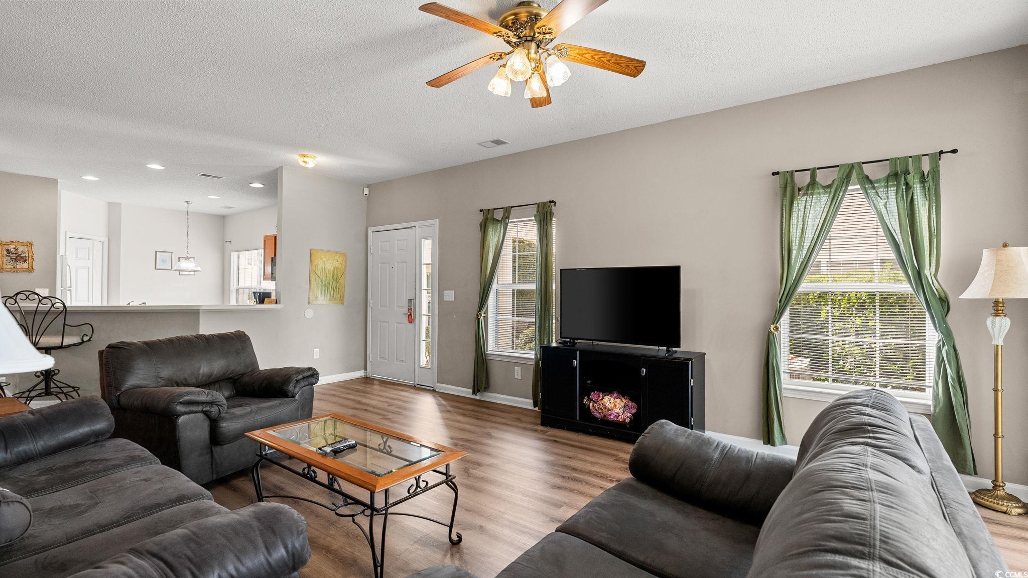 4431 Montrose Lane, Unit A Myrtle Beach, SC 29579 - Photo 7 of 32 Living room featuring a textured ceiling, wood finished floors, plenty of natural light, and ceiling fan