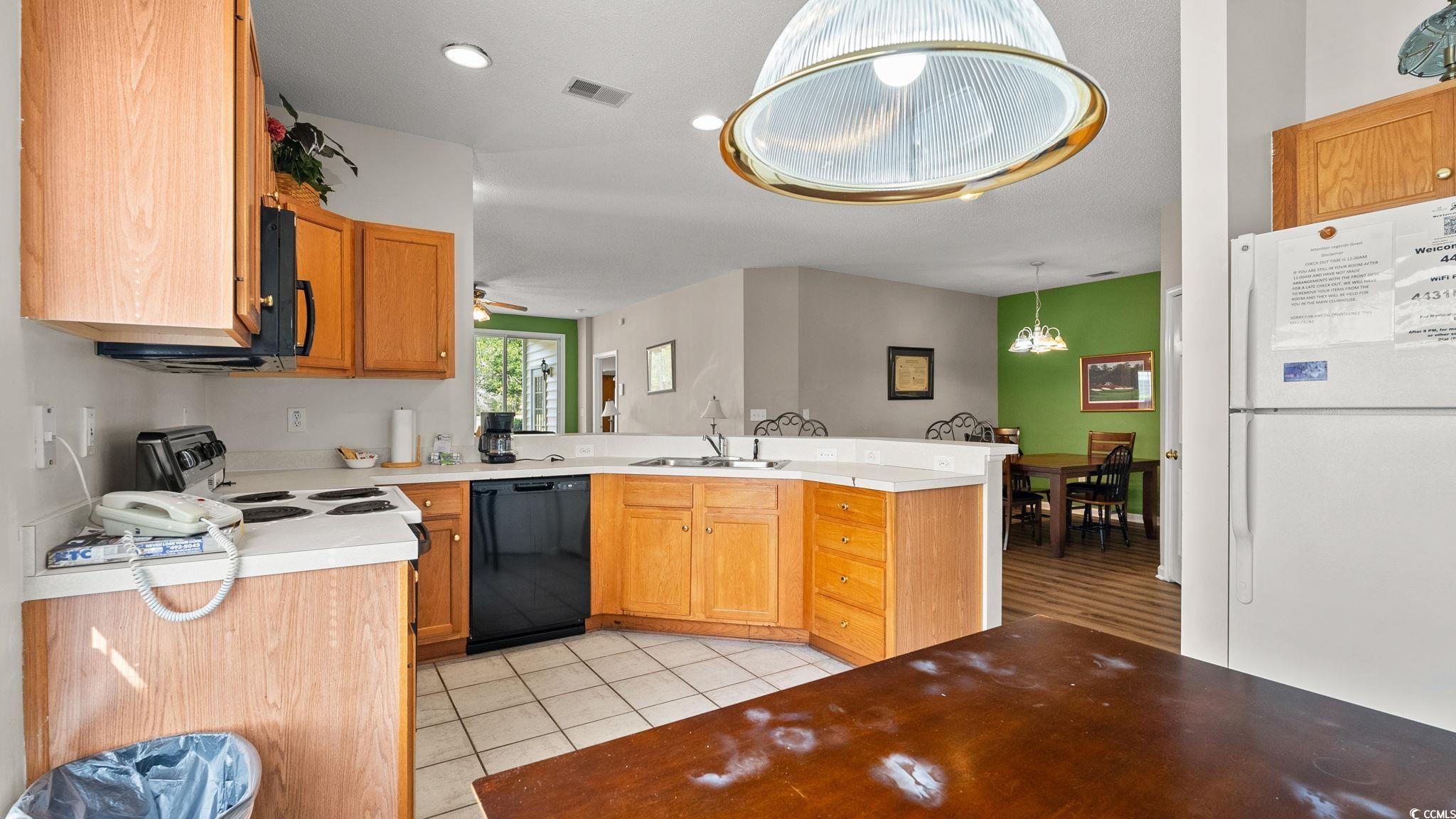 4431 Montrose Lane, Unit A Myrtle Beach, SC 29579 - Photo 8 of 32 Kitchen featuring black appliances, a peninsula, light countertops, hanging light fixtures, and recessed lighting