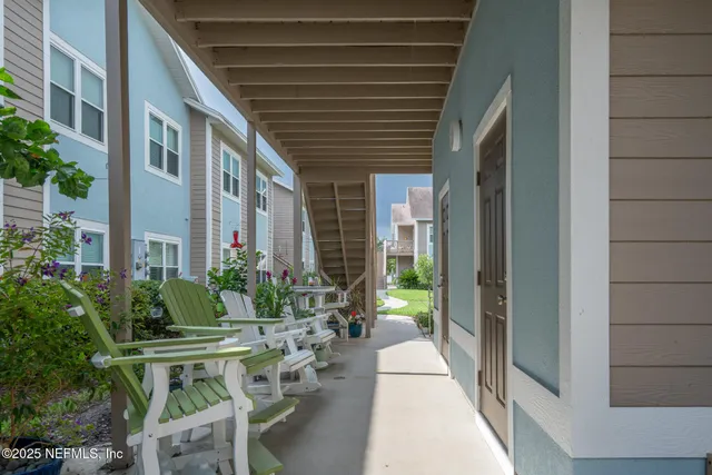 a view of an house with backyard and sitting area