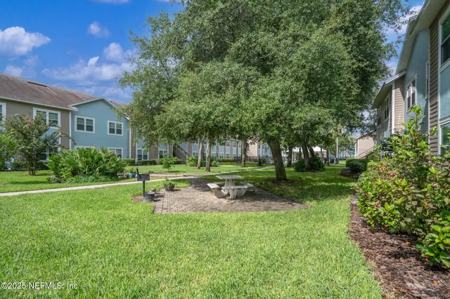 a view of a house with backyard and sitting area