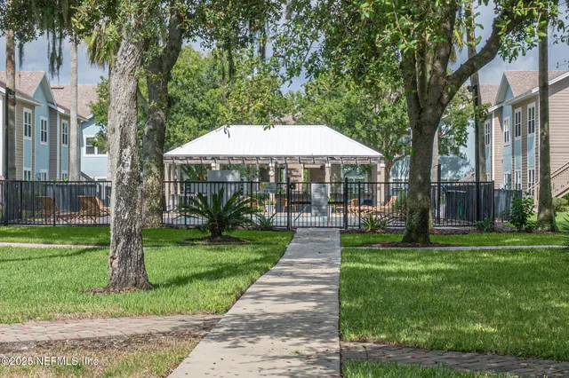 a front view of a house with yard and green space