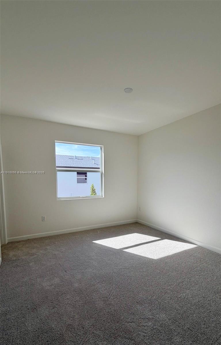 15592 Southwest 276th Terrace Homestead, FL 33031 - Photo 6 of 12 a view of an empty room and window