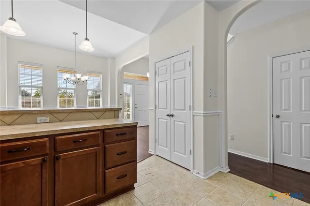 a spacious bathroom with a granite countertop sink a mirror and a shower