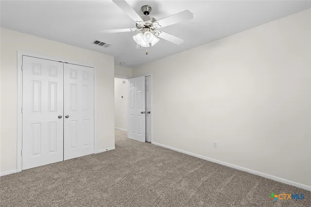 a view of a chandelier fan and entryway
