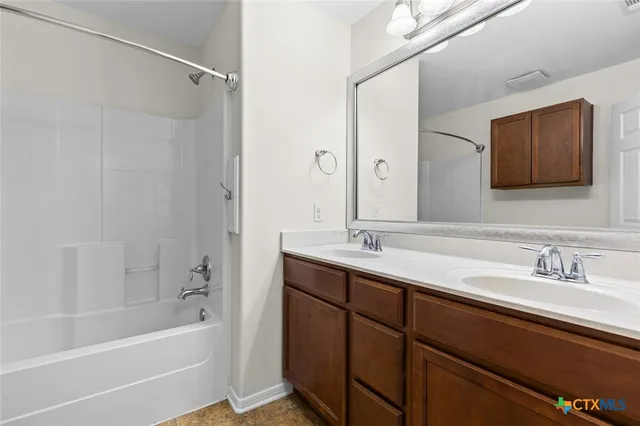 a view of an empty room with chandelier fan and a closet