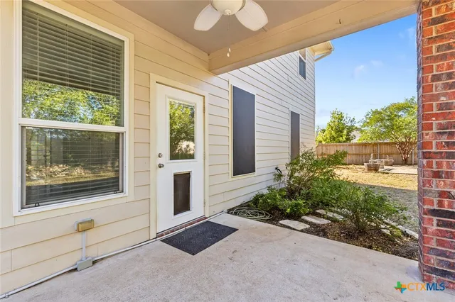 a view of backyard with small cabin and wooden fence