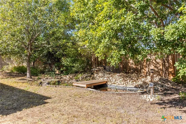 a view of a backyard with sitting area