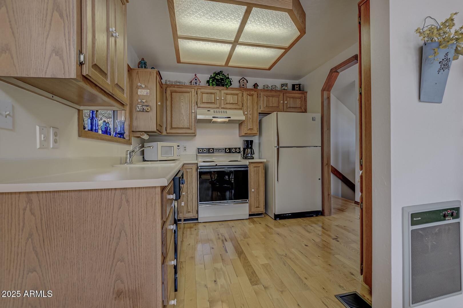5838 Arroyo Way Pine, AZ 85544 - Photo 13 of 53 a kitchen with refrigerator and cabinets