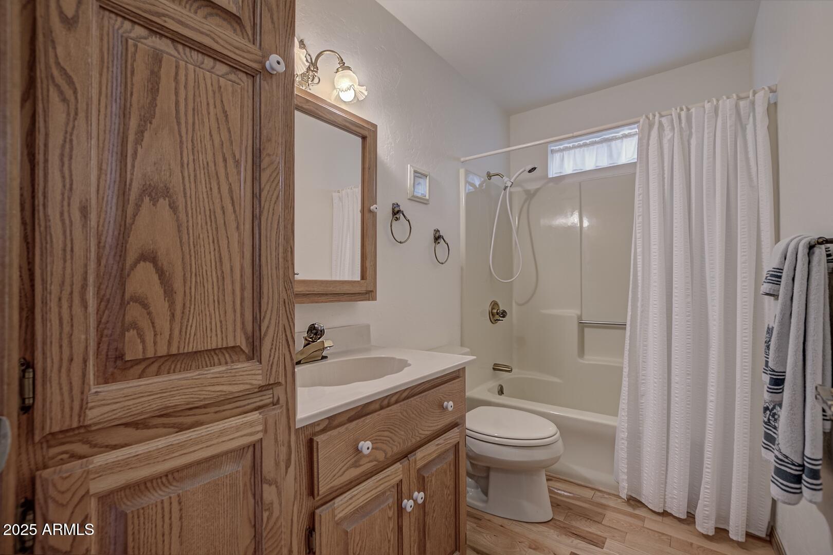 5838 Arroyo Way Pine, AZ 85544 - Photo 14 of 53 a bathroom with a granite countertop sink toilet a shower and a mirror