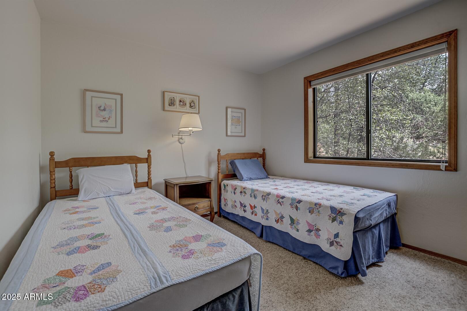 5838 Arroyo Way Pine, AZ 85544 - Photo 16 of 53 a bedroom with two beds and a window