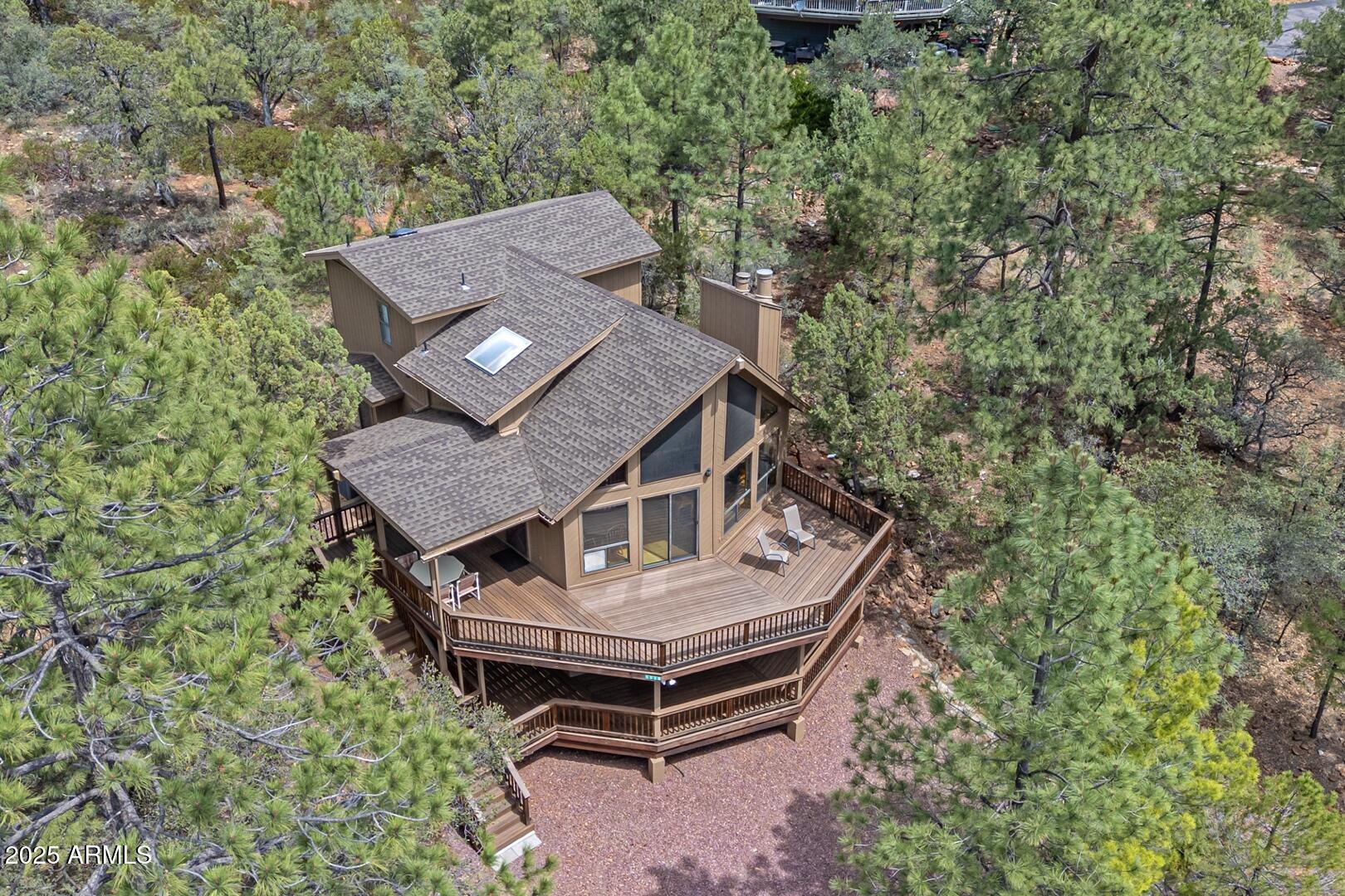 5838 Arroyo Way Pine, AZ 85544 - Photo 2 of 53 a view of a house with a yard and sitting area