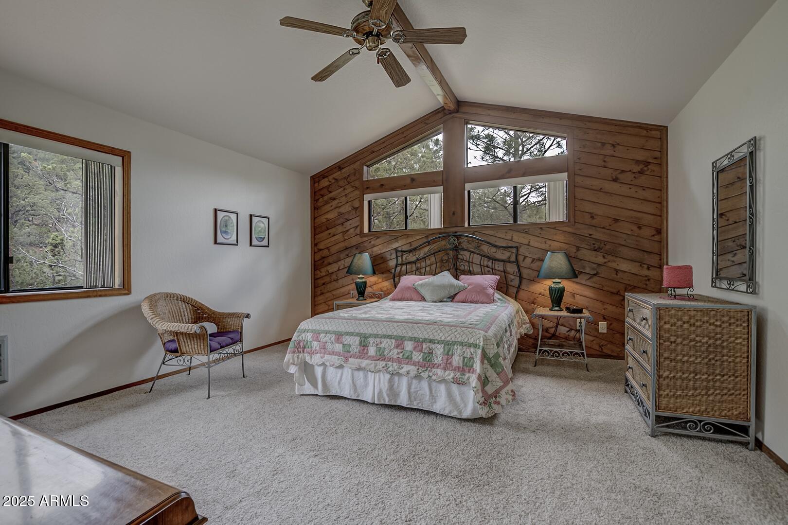 5838 Arroyo Way Pine, AZ 85544 - Photo 21 of 53 a bedroom with a bed and a chandelier