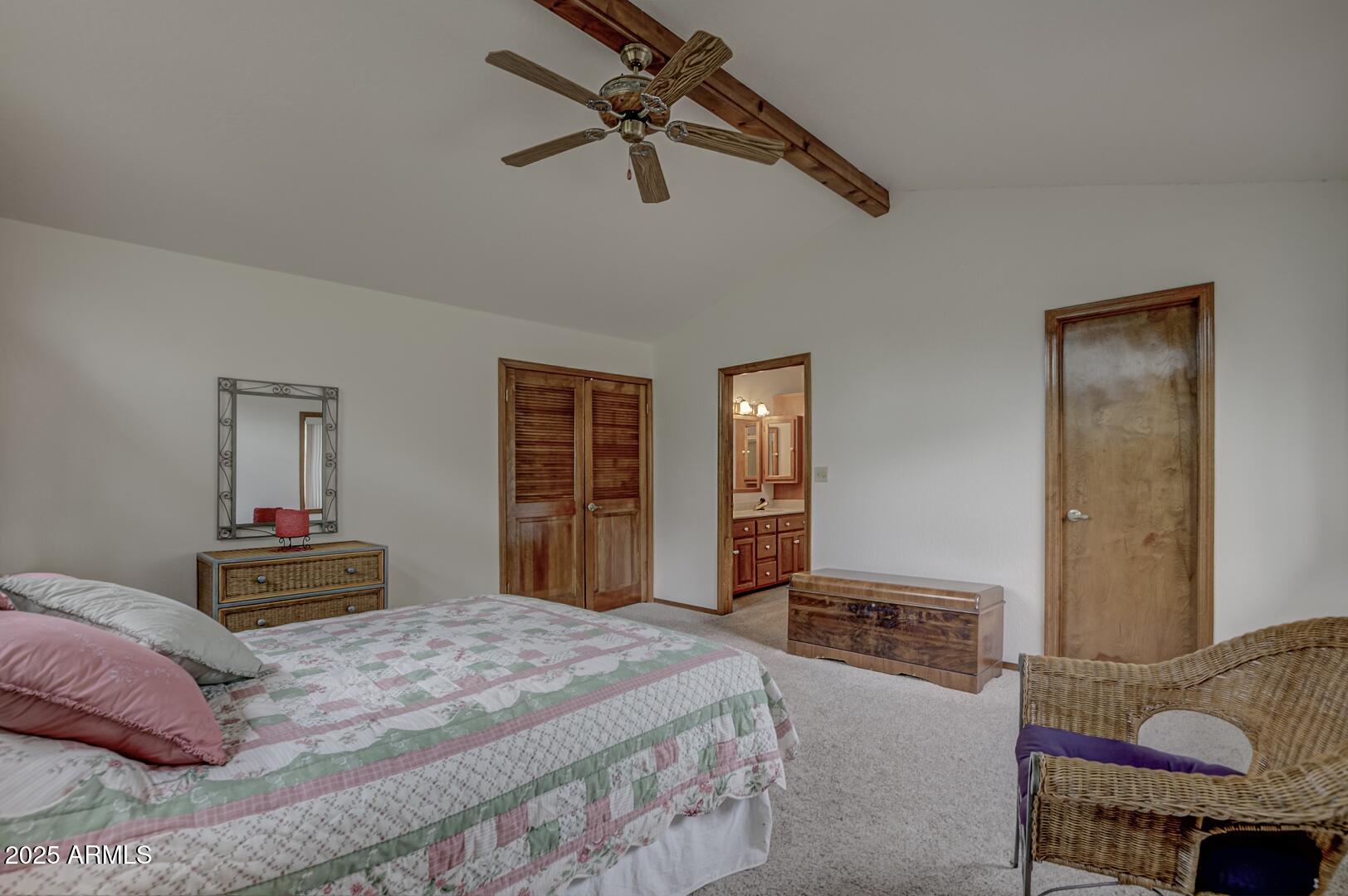 5838 Arroyo Way Pine, AZ 85544 - Photo 22 of 53 a bedroom with a bed and a chandelier