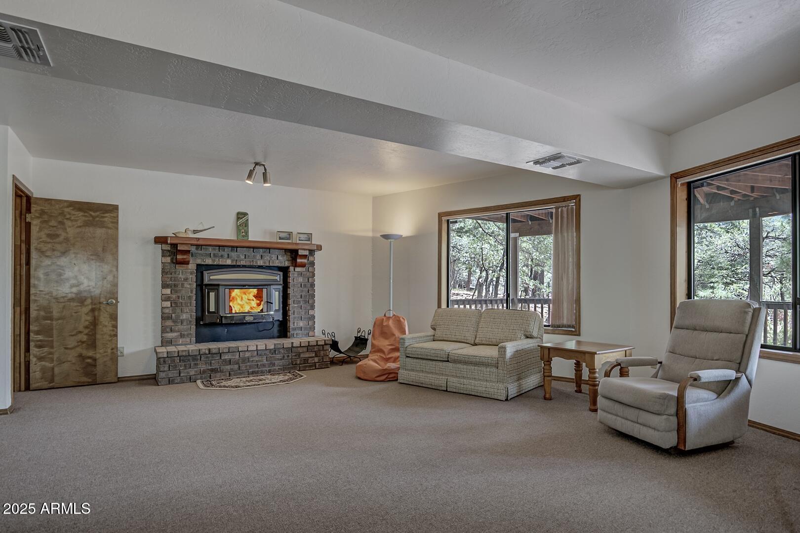 5838 Arroyo Way Pine, AZ 85544 - Photo 30 of 53 a living room with furniture and a fireplace
